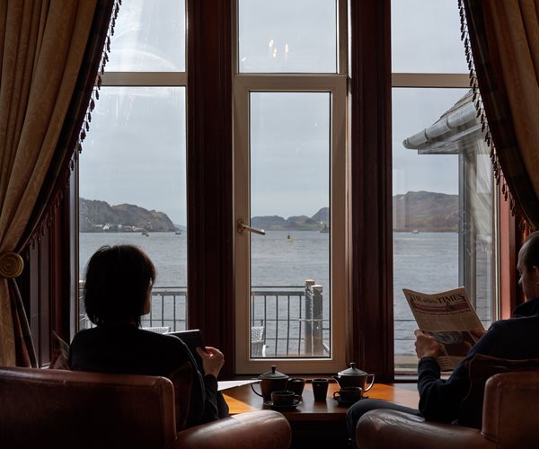 Couple Reading The Paper In The Sun Lounge At Oban Bay Hotel