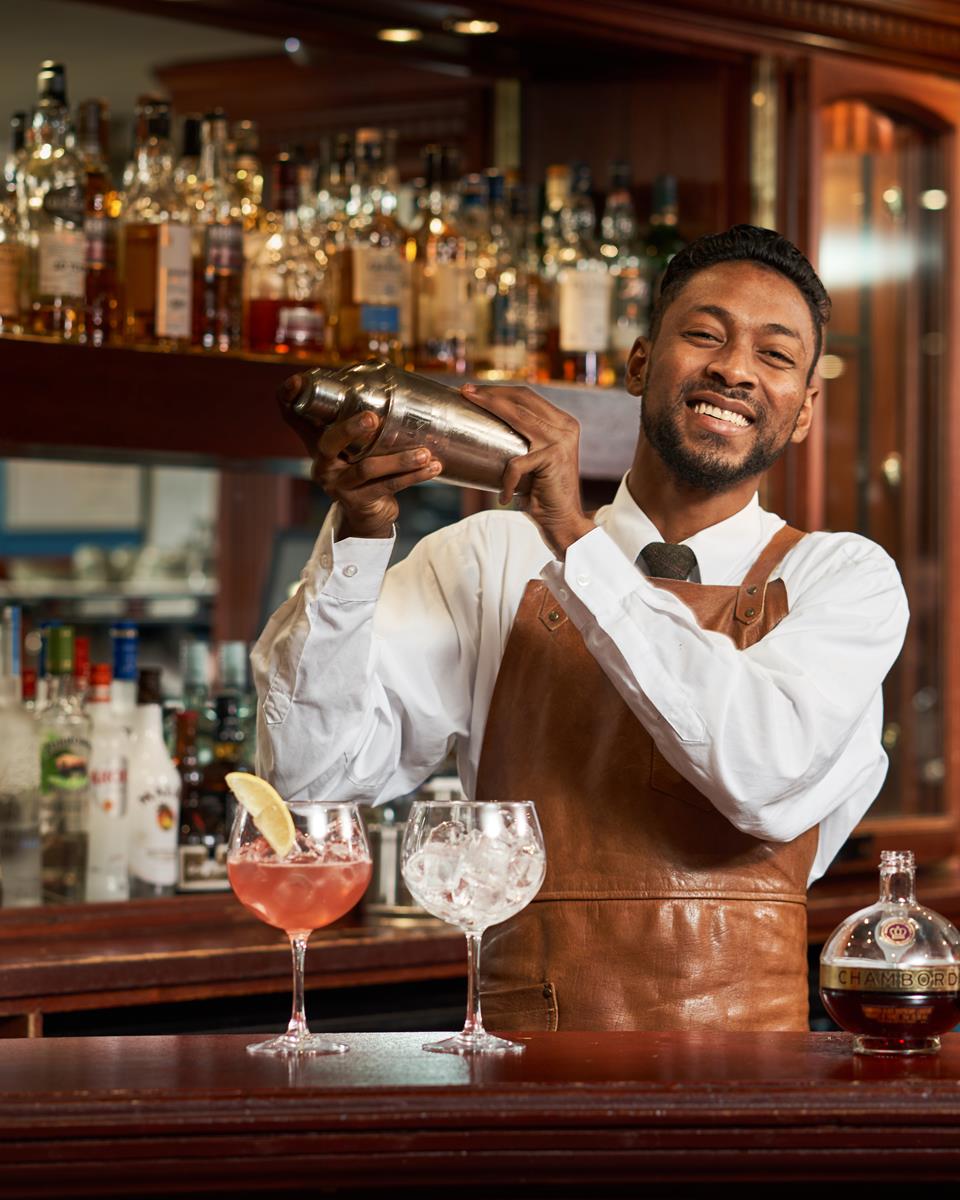 Barman Mixing Cocktails At Loch View Hotel Bar 