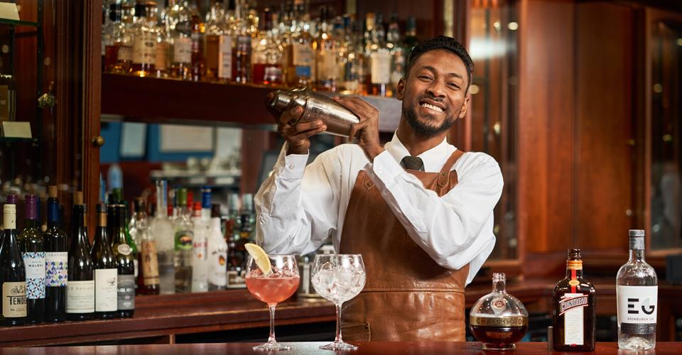 Barman Mixing Cocktails At Loch View Hotel Bar 