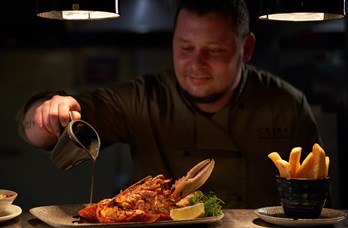 Crerar Chef Adding The Finishing Sauce To His Lobster Dish At Crerar Hotels Restaurant 