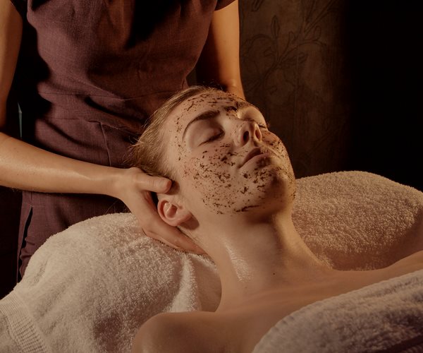 A woman receiving a relaxing facial massage. 