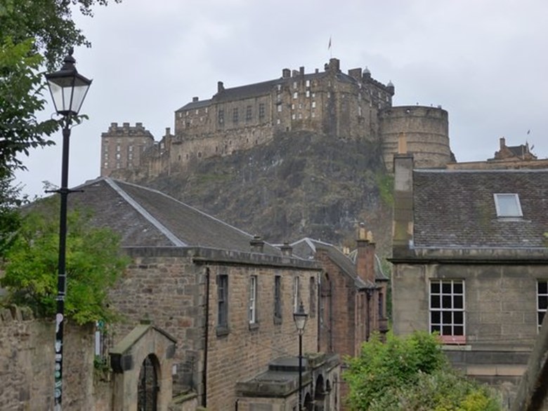 Landmark stairway between buildings, with views of Edinburgh Castle