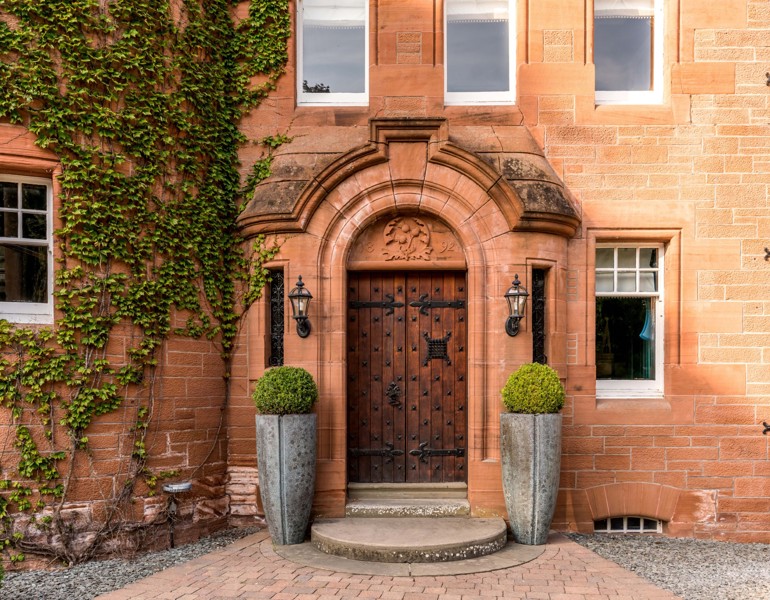 Wooden Castle Doors Surrounded by Brick With Ivy at Fonab Castle Hotel in Pitlochry ?? ''