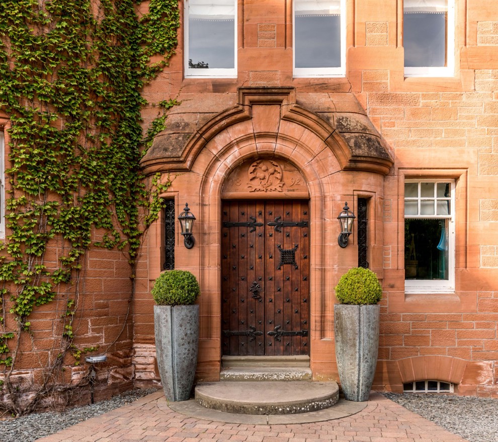 Fonab Castle | Wooden Castle Doors Surrounded by Brick With Ivy at Fonab Castle Hotel in Pitlochry ?? Fonab Castle