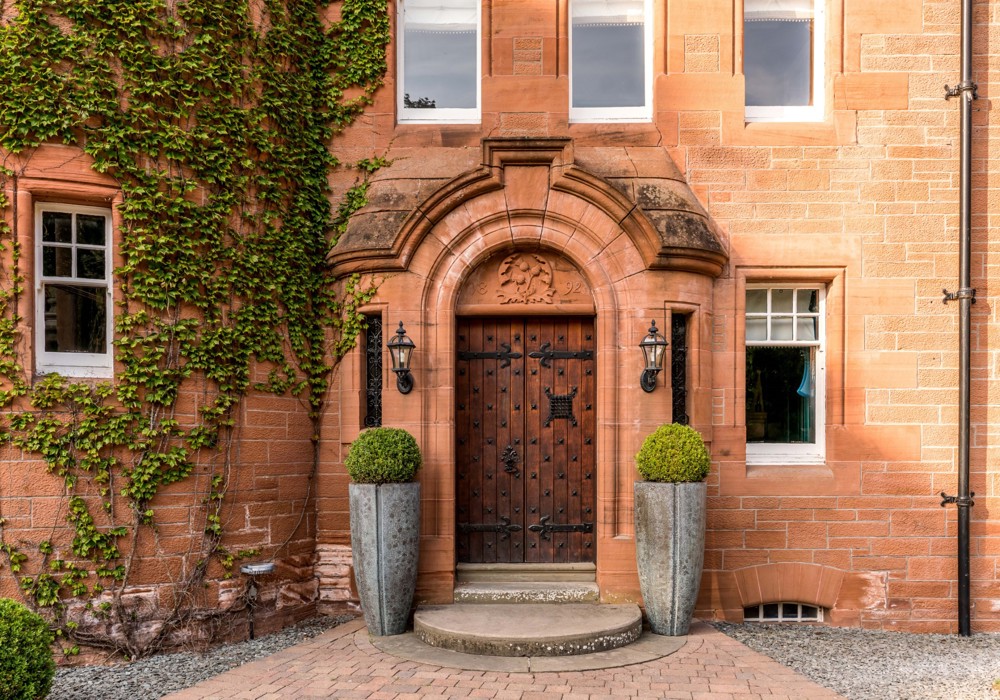 Fonab Castle | Wooden Castle Doors Surrounded by Brick With Ivy at Fonab Castle Hotel in Pitlochry ?? Fonab Castle