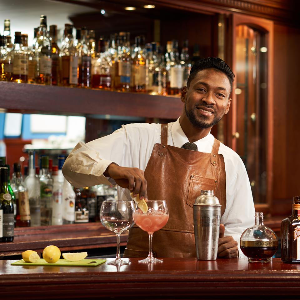 Barman Adding A Garnish To His Cocktail At Crerar Hotels Bar