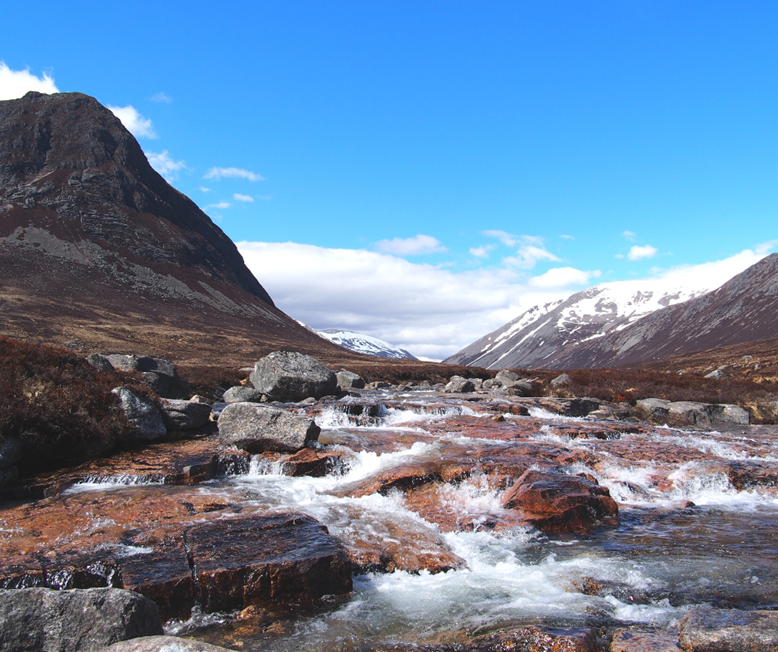 River through the two Lairigs walk with snowy mountain background