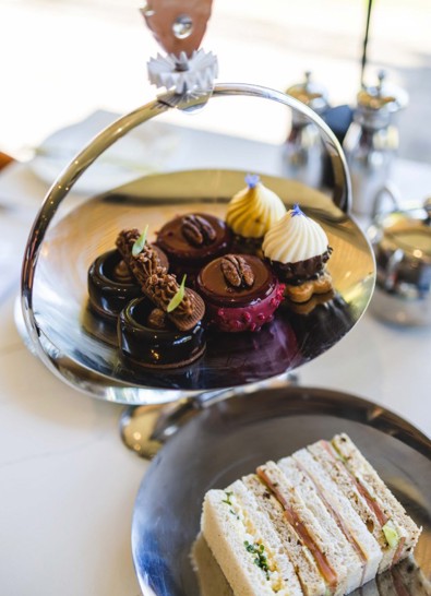 Cakes on cake stand and sandwiches during afternoon tea at luxury spa hotel in Scotland ?? ''